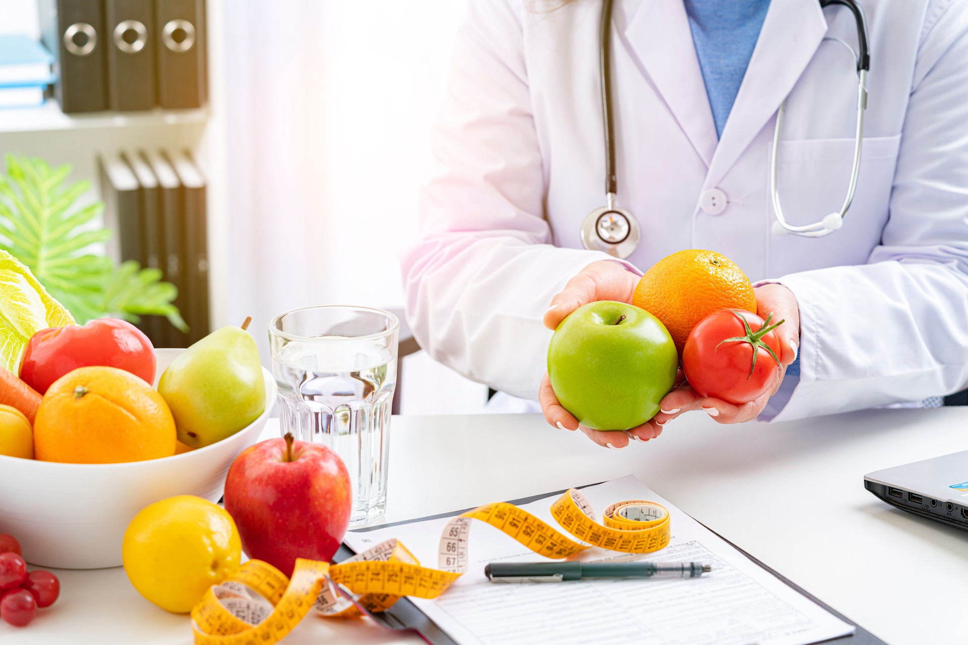 Close up of nutritionist holding some fruits and vegetables